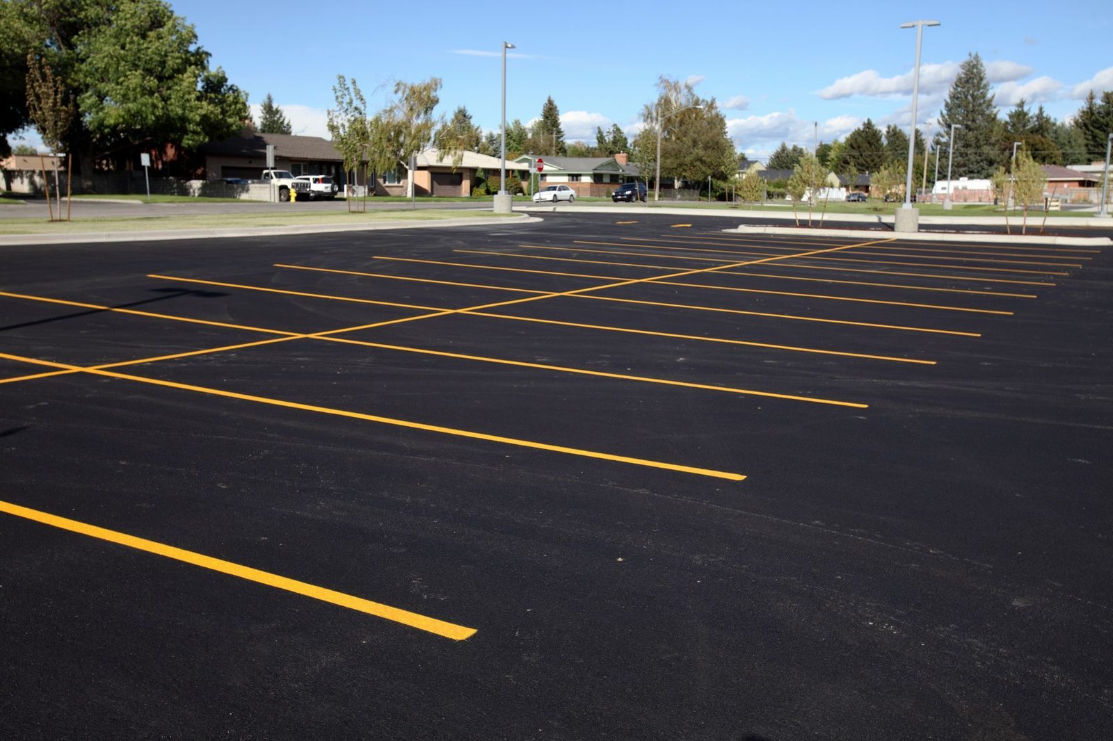 Fresh asphalt parking lot with crisp yellow striping