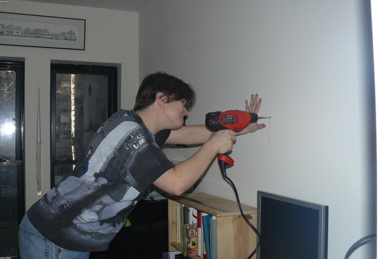 Handyman making a home repair with a cordless drill