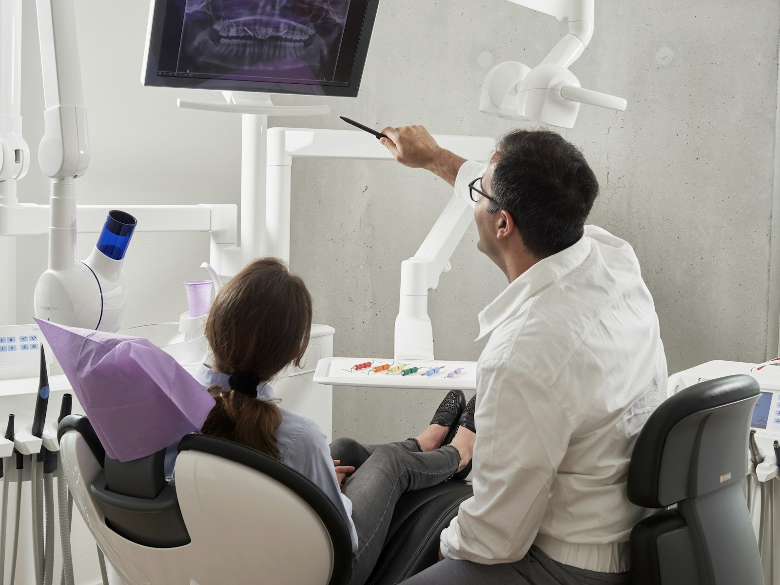 Dentist and happy patient discussing treatment