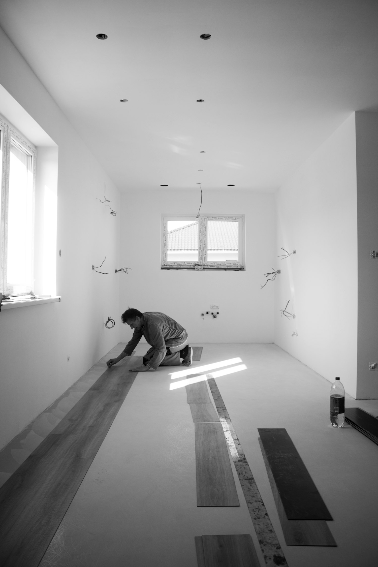 Craftsman installing hardwood plank flooring