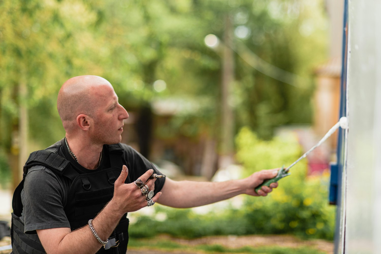 Pest control technician treating a home exterior