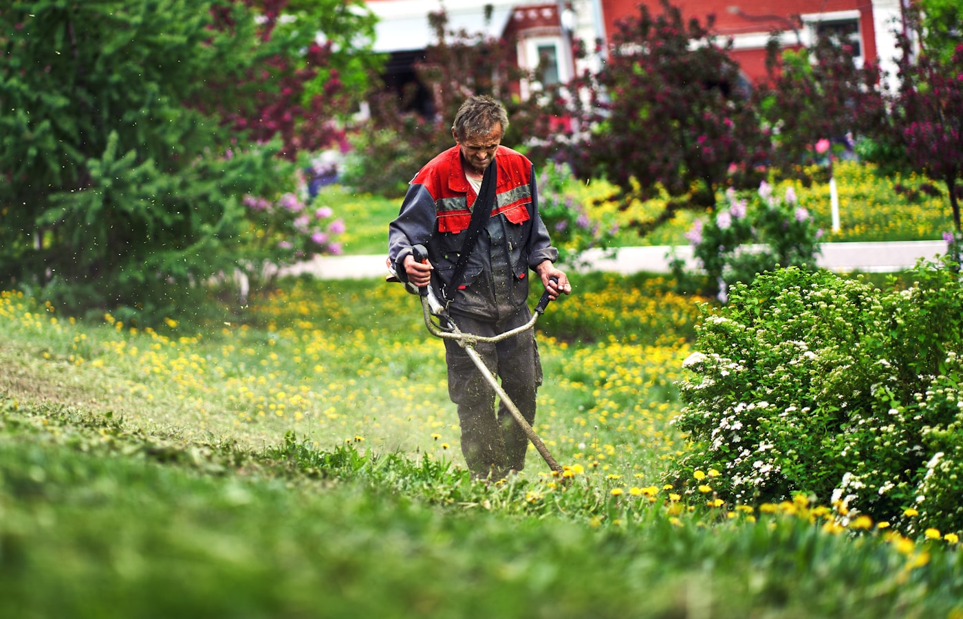 Technician trimming a garden bed