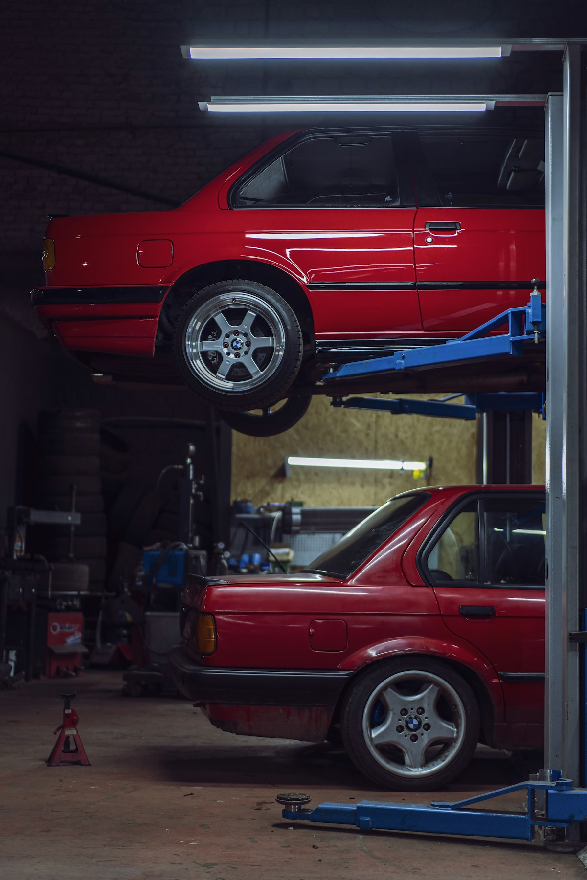 Vehicles on lifts in shop
