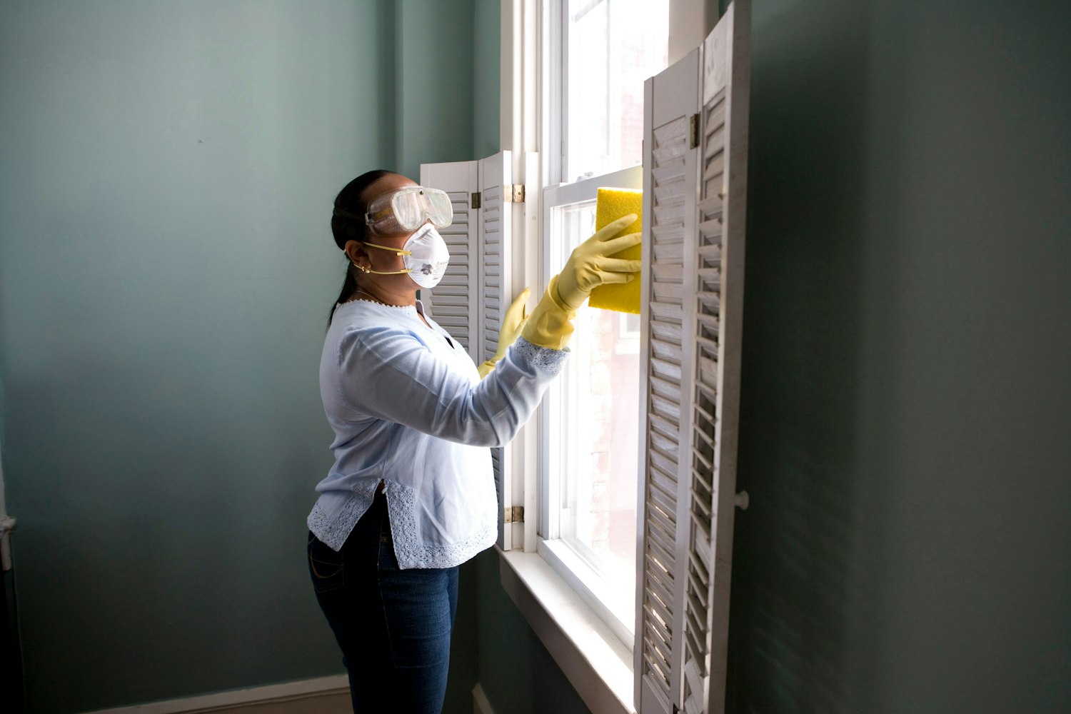 Professional cleaner tidying a bright home