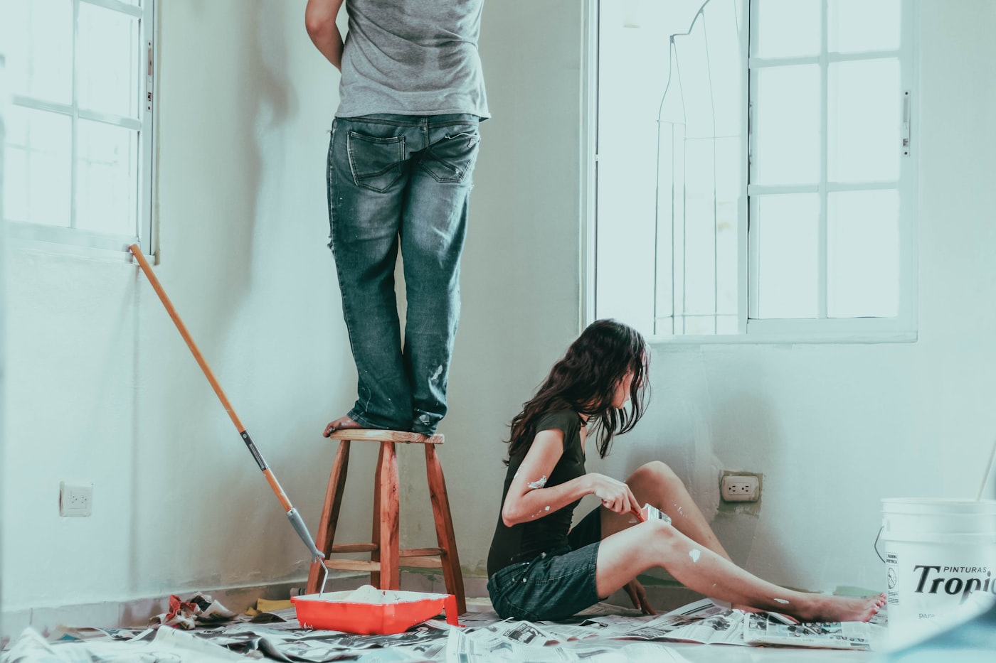 Painters cutting in a clean line on an interior wall